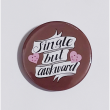 Badge with a brown background that reads "Single but awkward"