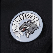 Pinback badge with banner reading "Wild Heart" and a snarling wolf